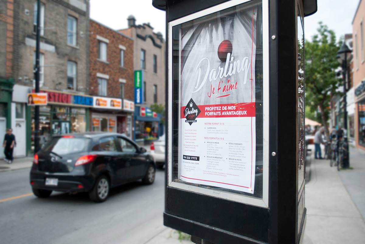 Affiche Darling dans une colonne Morris, sur la rue Ontario à Montréal